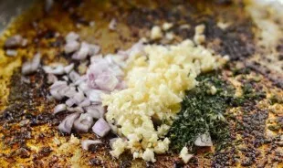 Then remove the brisket and replace it with finely chopped onion, garlic and thyme. Fry the ingredients for a few minutes until browned.