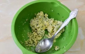 To prepare the filling, grate the cheese. Put chopped herbs and soft butter in it. Mix all the ingredients.