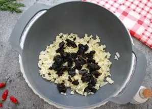 Chop the plums and add to the cabbage.
