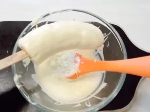 Coat the banana with chocolate on all sides.