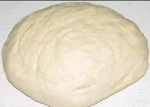 Our dough has risen. Sprinkle with flour and knead well. The dough should not stick to your hands.