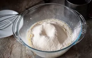 Sift flour and baking powder into this liquid mixture.