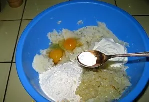 Add fried onions, eggs, flour, soda and sour cream.