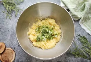 Finely chop the onion letters and herbs and add to the potato mixture.