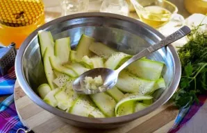 Squeeze a clove of garlic through a press.