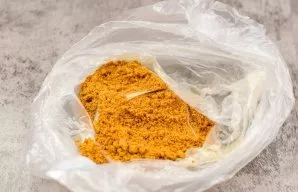 Put the cookies in a bag and crumble with a rolling pin or crush with a blender.