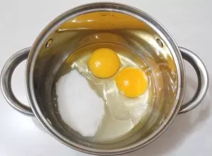 Add sugar and a small pinch of salt to the eggs.