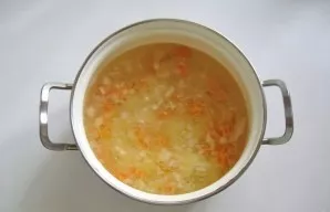 Then put onions and carrots in a saucepan. Continue cooking soup.