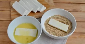 Dip each slice of cheese into the egg, then into the crumb and sesame seed mixture