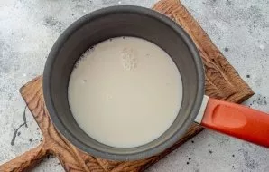 Pour milk into the scoop, bring to a boil and add salt.