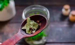 Add bay leaf, cloves, peppercorns.