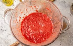 Crush the tomatoes into a homogeneous puree.