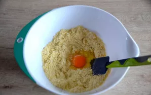 Beat the egg into the crumbly dough, knead the dough.