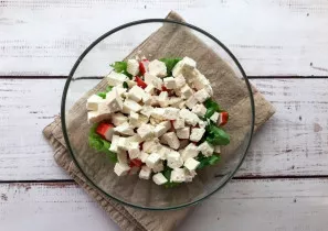 Cut the cheese into small cubes and put it on a plate.