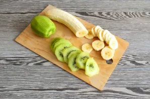 Peel the kiwi and banana. Cut the fruit into thin slices.