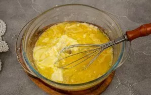 Pour in the melted butter and mix well again.