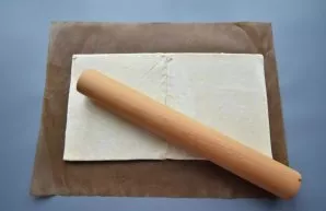 Defrost the frozen puff pastry in advance and roll it into a rectangular layer 1-2 mm thick. So that the dough does not stick to the surf...