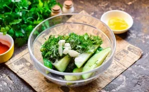 Add salt and crushed young garlic to cucumbers.