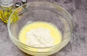 Add two tablespoons of wheat flour to the eggs. Shake everything up again.