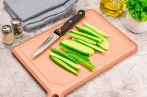 Rinse and dry fresh cucumbers. Cut the cucumbers into long strips.