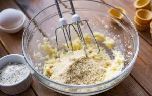 Add almond flour to this creamy butter mixture. Using a mixer at low speed, stir the flour until smooth.