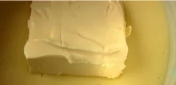 When the cream has cooled slightly, add the butter and stir until it dissolves.