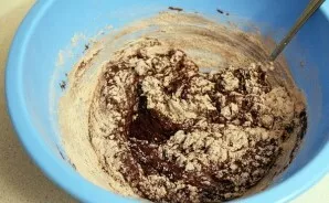 Add all the dry ingredients to the resulting butter-chocolate mixture. Mix well.