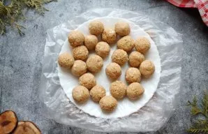 Divide the mixture into equal parts and roll it into balls the size of macadamia nuts and put on a plate with cling film. Place the plate...