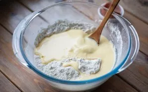 Pour the liquid mixture into a mixture of dry flour.