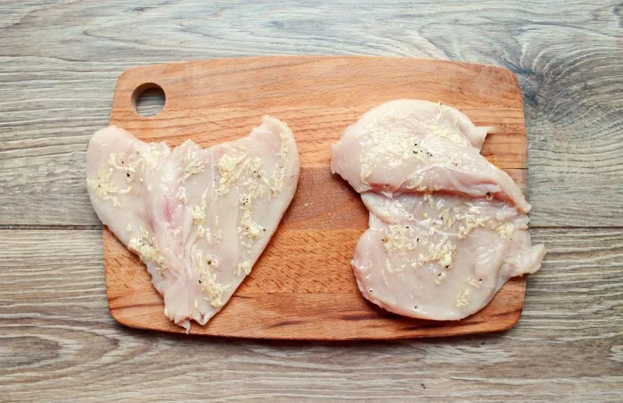 Spread the prepared garlic mixture on the breasts.
