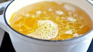 Pour in the broth and bring to a boil.