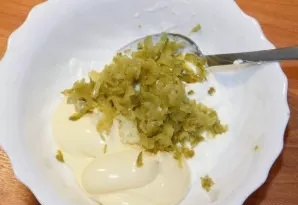 For dressing mix sour cream, mayonnaise, grated garlic and cucumbers. Stir.