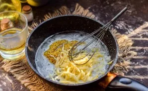 Then put mustard and hard cheese, grated with shavings, in a pan. While stirring, cook the sauce over low heat.