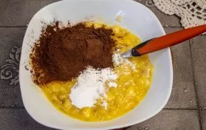 Add cocoa powder and baking powder and mix.