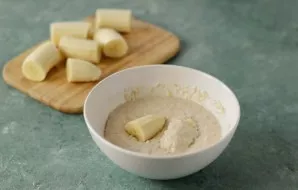 Dip the bananas in the dough.