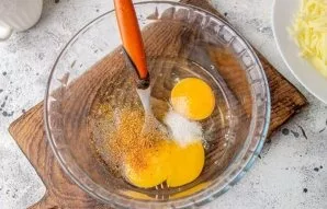 Break eggs into a bowl, add salt and pepper, mix.