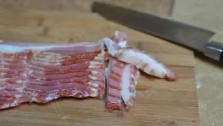 Cut the bacon into small cubes.