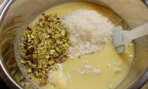 Add a mixture of zucchini, lemons, and eggs to the dry ingredients along with the pistachios and coconut.