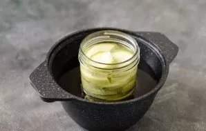 Pour water into the jar to the shoulders of the jar. Put in a saucepan, pour water to half. Add salt and all spices to the jar. Pour vine...