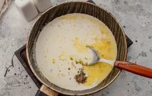 Pour in the cream. With constant stirring, bring to a boil.