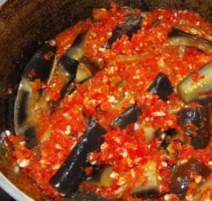 Transfer the boiled eggplants to the pot with the sauce and simmer for another 5 minutes.