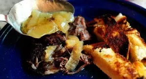 Place the beef and onions on plates and top with the remaining cooking sauce. Serve the beef with slices of toasted white bread and mashe...