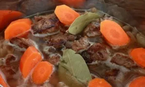 Pour in the wine, again add the meat, crushed carrots, bay leaf, allspice and black pepper and salt. Pour water until it barely covers al...