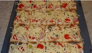 Then spread the halved cherry tomatoes and sprinkle with grated cheese.