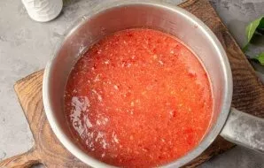 Pour the prepared tomato puree into a thick-bottomed saucepan. Put on the stove and bring to a boil. Cook on minimal heat and simmer for ...
