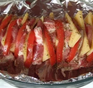 Now put a couple of garlic, cheese and tomatoes in the cuts we made. Top with some salt and pepper.