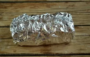 Wrap the resulting roll in foil and bake for 20-25 minutes. 8-10 minutes before the end, unwrap the foil to form a crust.