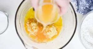 Then mix the eggs with citrus sugar, vanilla extract, juice, oil and apple sauce.