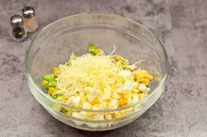 Also cut the boiled eggs into small cubes and add to the salad. Add finely grated hard cheese to the salad.