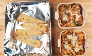 Next, transfer to a baking sheet. Grate both types of cheese on top. Bake the ingredients at a temperature of 180 degrees for 19 minutes....